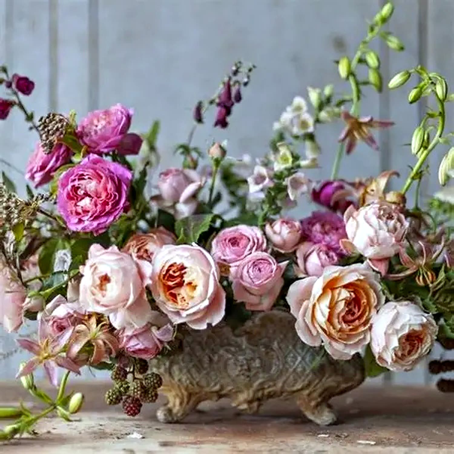 Blush and peach garden roses in a low urn